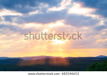 Rays of the sun through the clouds in the mountains