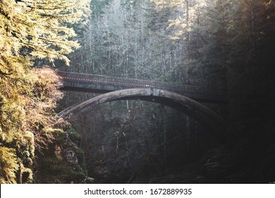 Rays Of Sunlight Cast Across The Wooden Bridge At Moulton Falls In Battle Ground, Washington, USA.