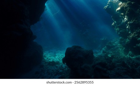 Rays of sunlight inside a cave underwater