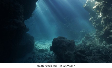 Rays of sunlight inside a cave underwater