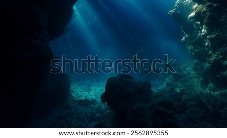 Rays of sunlight inside a cave underwater