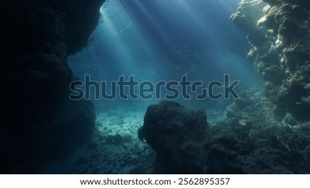 Rays of sunlight inside a cave underwater