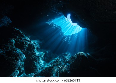 Rays of sunlight shining into the cave, underwater view