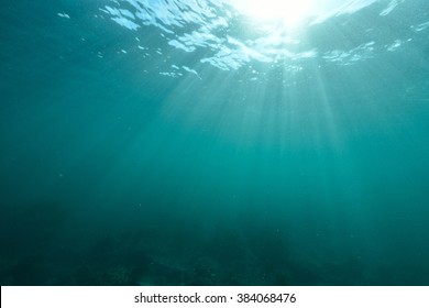 Rays of sunlight shining into sea, underwater view - Shutterstock ID 384068476