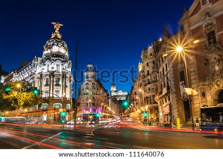 Rays of traffic lights on Gran via street, main shopping street in Madrid at night. Spain, Europe.