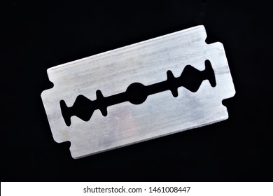 Razor blade on black background. The razor blade is a flat metal plate, it is a shaving tool. The blades for hair removal, have two sharpened cutting edges, installed in the shaving machine.