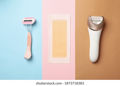 Razor, Epilator And Wax Strip On Three Tone Background