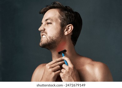 Razor, hurt or man in studio with pain or hair removal for skincare tools, face grooming or cosmetics. Uncomfortable, rough irritation or model on grey background for beauty, shaving neck or wellness - Powered by Shutterstock