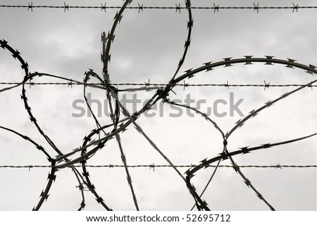 Similar – Fence with a barbed