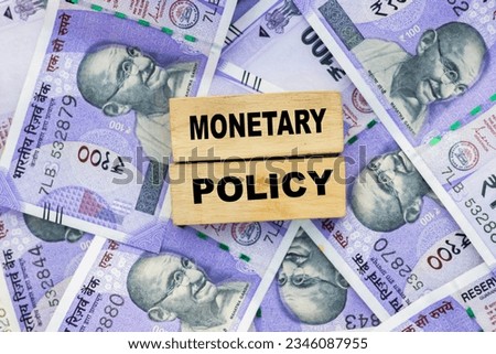 RBI monetary policy word on wooden block place on indian currency