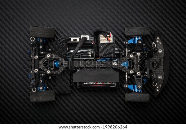 RC car chassis and parts being assembled to\
form a radio controlled race\
car.