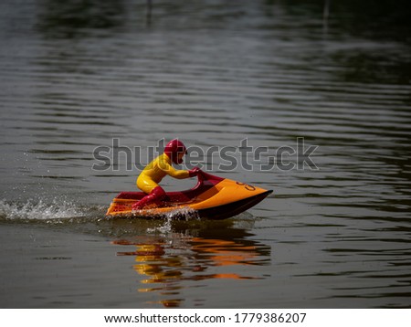 RC controlled jet ski model on lake. Active summer vacation for school child.