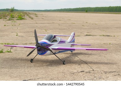 RC-Model Airplane With Remote Control. Model Aircraft For Acrobatics. The Model Stands On The Runway Of The Airfield.