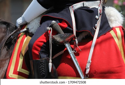 RCMP Officer Wearing A Sabre, Holding The Reins With White Gloved Hands, While Sitting In Uniform On A Horse During A Parade