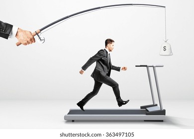 Reach a goal concept with businessman running on a treadmill for money 