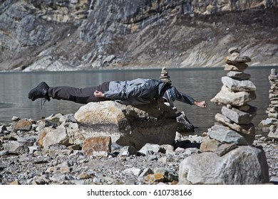 Reach The Goal. Superman On The Stone. Planking. Man Flies With Arm Outstretched