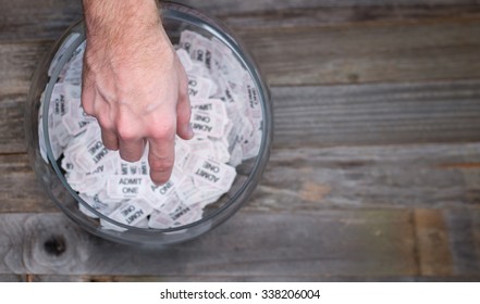 Reaching Into A Bowl Of Raffle Tickets To Find A Winner