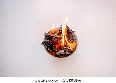 Reaction chemical chemistry concept, combustion reaction, fire flame burning chemistry reagents on crucible on white background, baking powder or sodium bicarbonate and sugar is science show activity