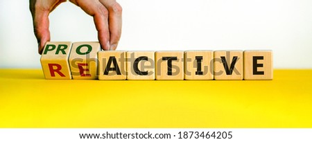 Reactive or proactive symbol. Businessman hand turns cubes and changes the word reactive to proactive. Business and reactive or proactive concept. Beautiful white background, copy space.