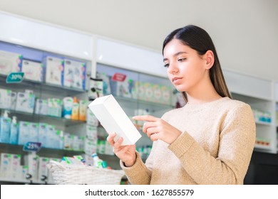 read drug instruction. woman reading instruction or label of the product in pharmacy or store