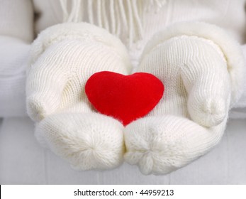 Read Heart On Female Palms In White Warm Wool Gloves Representing Valentine's Day Concept