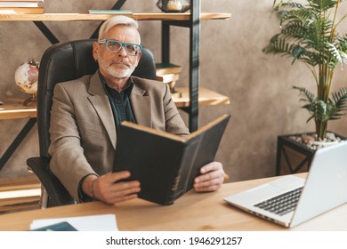 Read At Your Leisure. Grandpa Is Holding A Book, A Popular Bestseller. Aged Literary Critic.