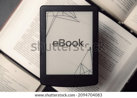 Readers. Digital e book, library reader tablet with books on dark background. Ebook, e learning electronic internet mobility concept.