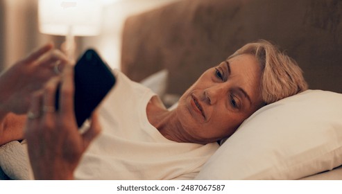 Reading, bed and senior woman with phone for online blog on insomnia, sleep apnea or relaxing. Communication, night and mature female person networking with email on smartphone in bedroom at home. - Powered by Shutterstock