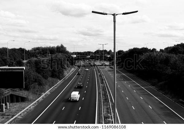 Reading,\
Berkshire, England - August 30, 2018: monochrome M4 motorway at\
junction 12, road run between London and Wales and is the busiest\
in Europe and known as the m4\
corridor