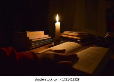 Reading A Book By Candlelight