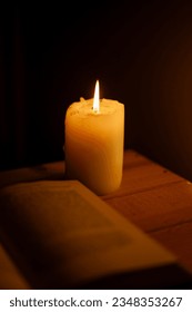 reading book in candlelight on a wooden board