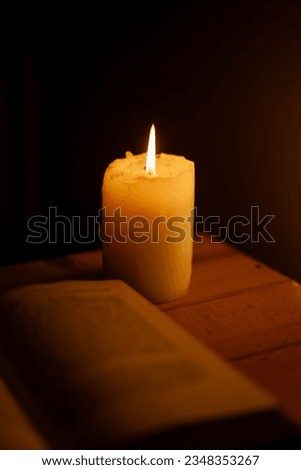 reading book in candlelight on a wooden board