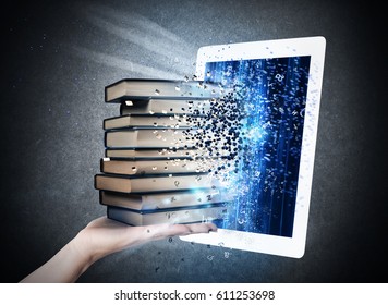 Reading books with an E-book - Shutterstock ID 611253698
