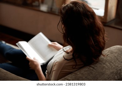 Reading, books and woman on sofa to relax in bookstore, library or shop for research, learning and study. Literature, knowledge and person with book for education, information and studying for hobby - Powered by Shutterstock