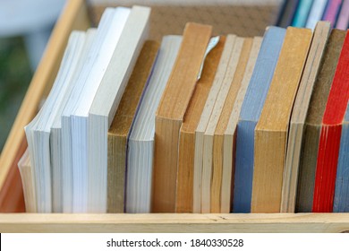 Reading Concept, Selective Focus Of Old Books In Wooden Crate Place Outdoor For Donate, Multicolour Of Vintage And Classic Books In The Wooden Box.