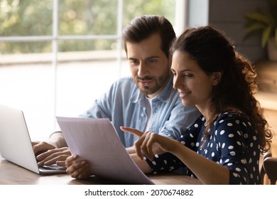 Reading documents. Family couple study papers search information by loan mortgage affordable housing program on website. Young spouses clients hold bank account statement check financial data online - Shutterstock ID 2070674882