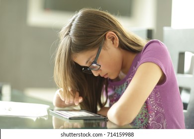 READING AND DOING HOMEWORK, Teenager Doing Homework At Home, And With Ipad, State-of-the-art Technology At The Forefront