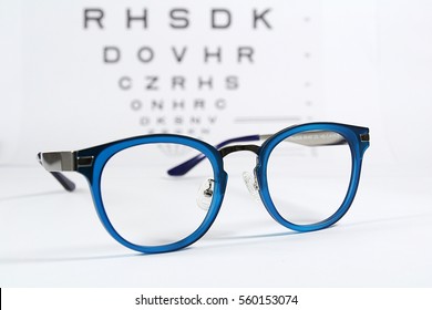 Reading Eye Glasses With Eye Chart Isolated On White