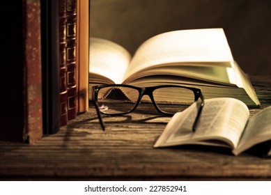 reading glasses with books on the table
