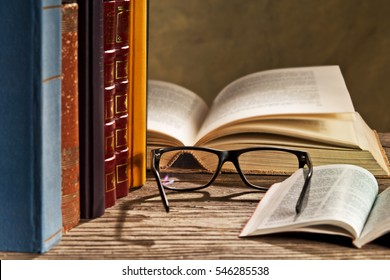 reading glasses with books on the table