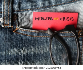 Reading glasses in jeans pocket with handwritten text on note MIDLIFE NO CRISIS - to overcome crisis on transition of identity and self-confidence usually occur in middle-aged 45 to 65 years old