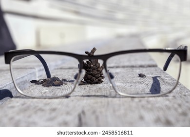
reading glasses on a wooden bench for reading a book