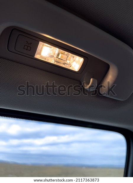 Reading light turned on inside a van car\
during people\
transportation.