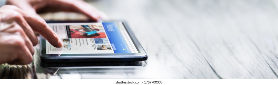 Reading Newspaper Article Online On Digital Tablet