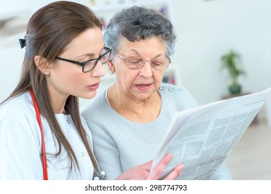 Reading Newspaper With An Old Lady