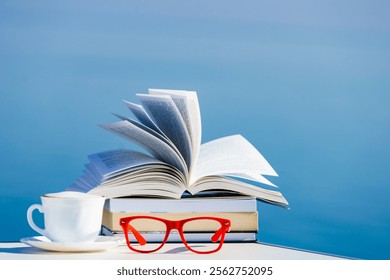 Reading on vacation. Coffee cup, book and red glasses against blue sea water. Relaxation on holidays trip. Mental health break. - Powered by Shutterstock