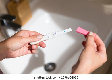 Reading of a positive pregnancy test.