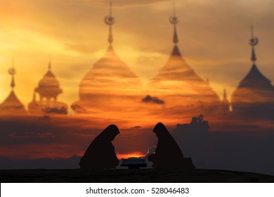 reading  Quran  concept, women praying Friday Puasa Ramadan for fasting concept: Islam humility asking god, buildings from a mosque, open Coran to opportunity heaven and belief, having worship