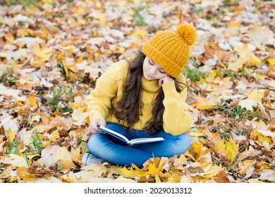 Reading really matters. Little child read book sitting on fall leaves. School library. Knowledge and informaiton. Imagination and fantasy. Literacy education. Reading grows on you