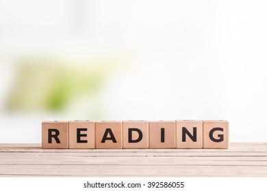 Reading sign made of wood on a table - Shutterstock ID 392586055
